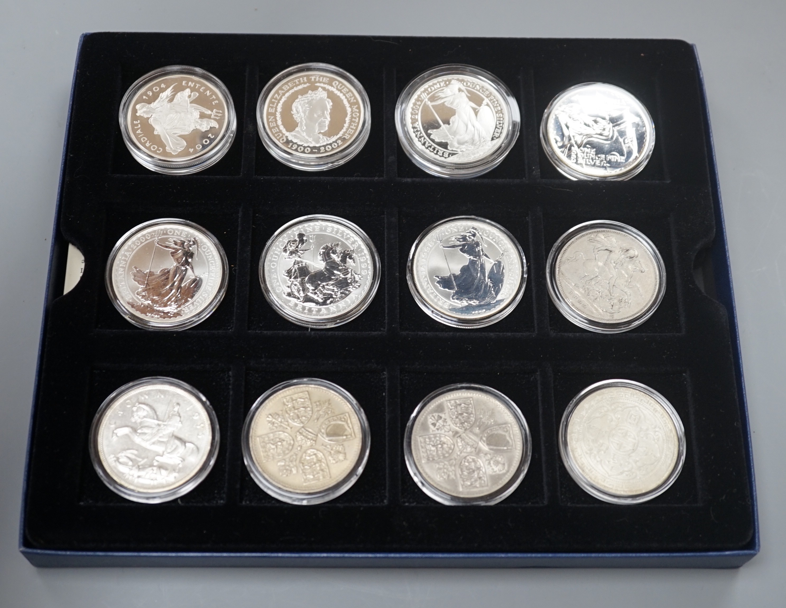 A group of coins including 1898 British Trade One Dollar, Royal Mint UK two QEII five shillings, 1935 crown, 1890 crown, silver proof coins - five 1oz. silver Britannia £2 coins 1998-2000, 2003, 2004, 2002 Queen Mother £